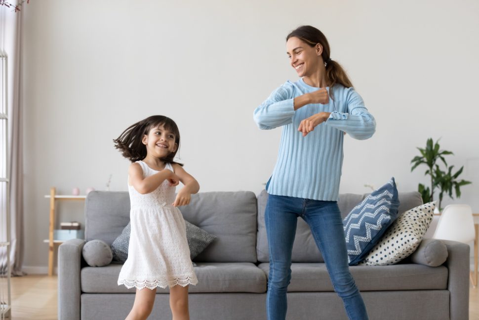 mother and daughter dancing in living room ways to exercise without a gym BodyViva
