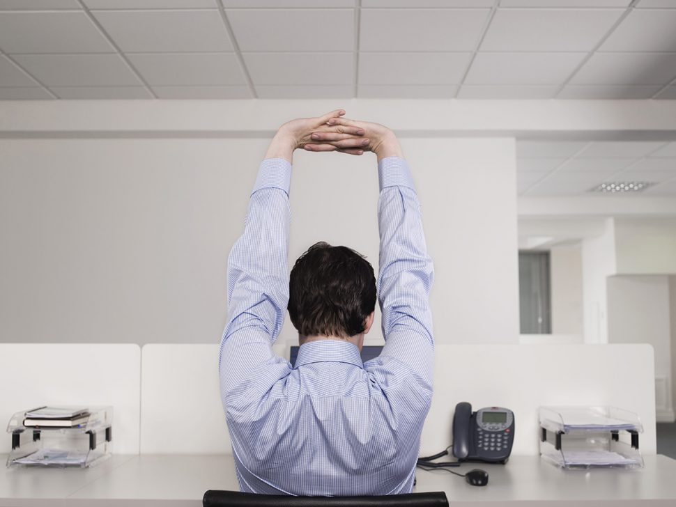 man stretching at office desk BodyViva exercise at your desk
