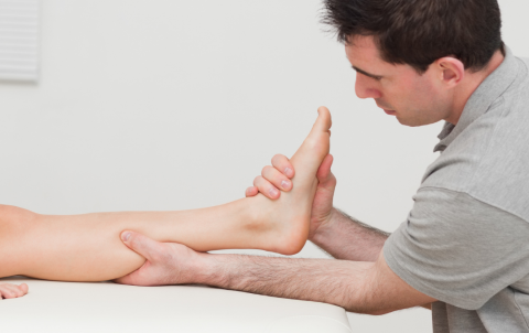 therapist massaging tendon
