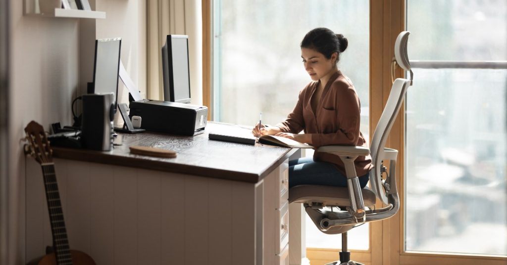 woman sitting at ergonomic desk